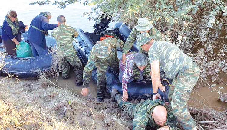 Μόνο υπερηφάνεια μπορούν να νιώσουν οι γονείς, η σύζυγος και οι συνάδελφοι του πεζοναύτη Στάθη Κοτρέτσου που με αυτοθυσία πέφτει στις λάσπες για να περάσει από επάνω του μία υπερήλικη, ανήμπορη γυναίκα, ώστε να πατήσει σε στεγνό έδαφος κατά την αποβίβασή της από τη λέμβο